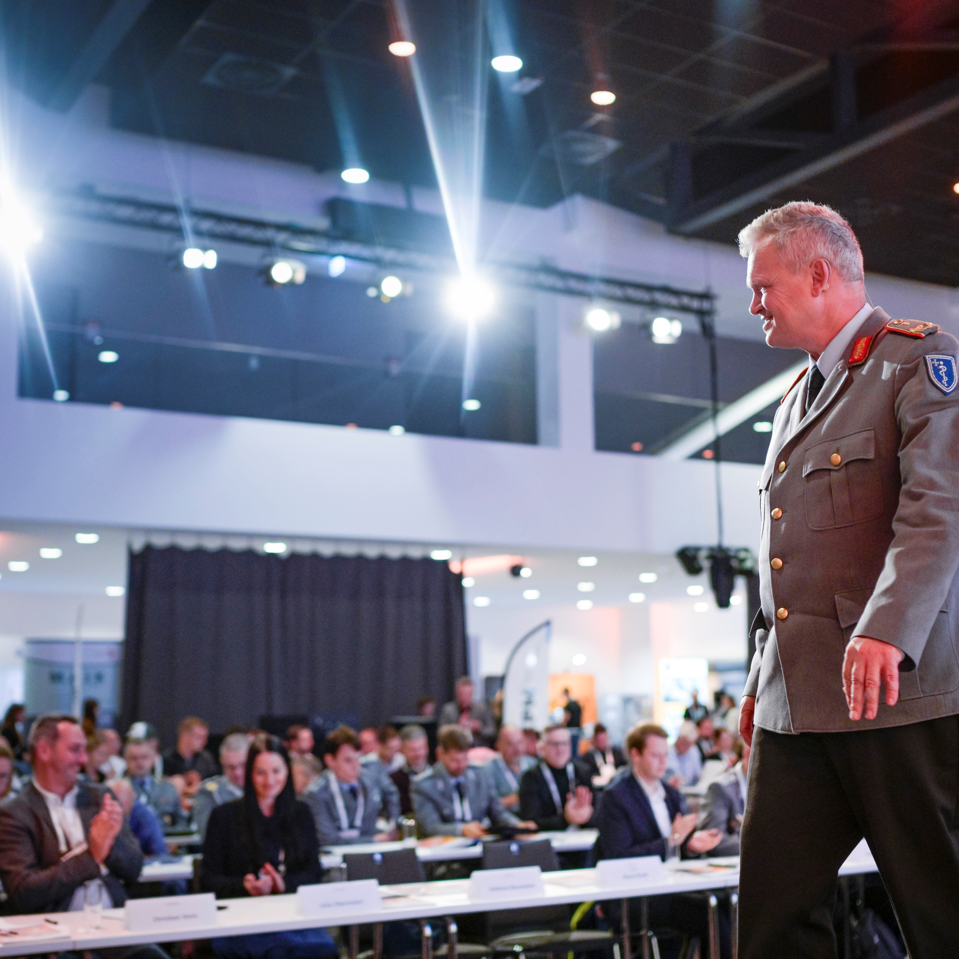 Mann in Uniform auf der B&uuml;hne vor dem Publikum des CP Symposiums im Parksaal.